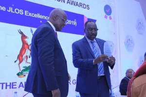 The Solicitor General Mr. Francis Atoke receiving the 2019 JLOS Excellence Award on behalf of the Office of the Administrator General (Ministry of Justice and Constitutional Affairs) during the 2019 JLOS Recognition Awards Ceremony on 12th November 2019 (PHOTO: JLOS)